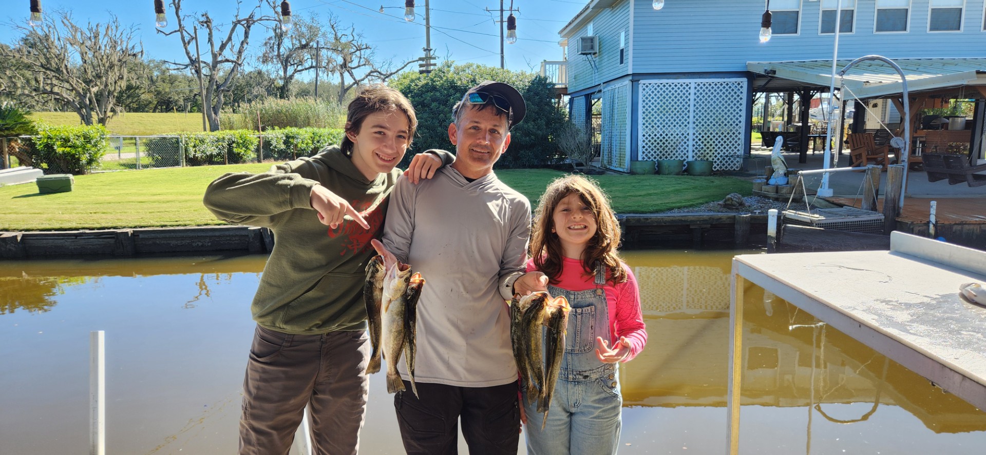 Two BFF members on the boat holding up a trophy-sized redfish catch