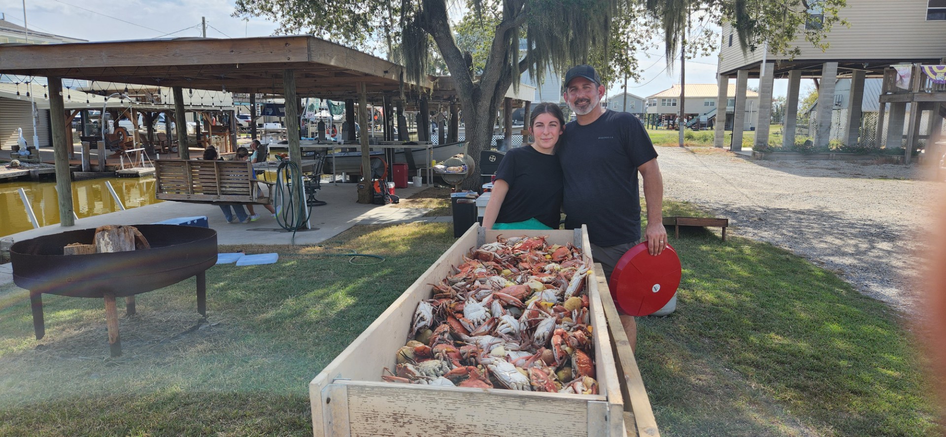 BFF member hauling a crab trap from the boat during a crabbing trip on the bayou