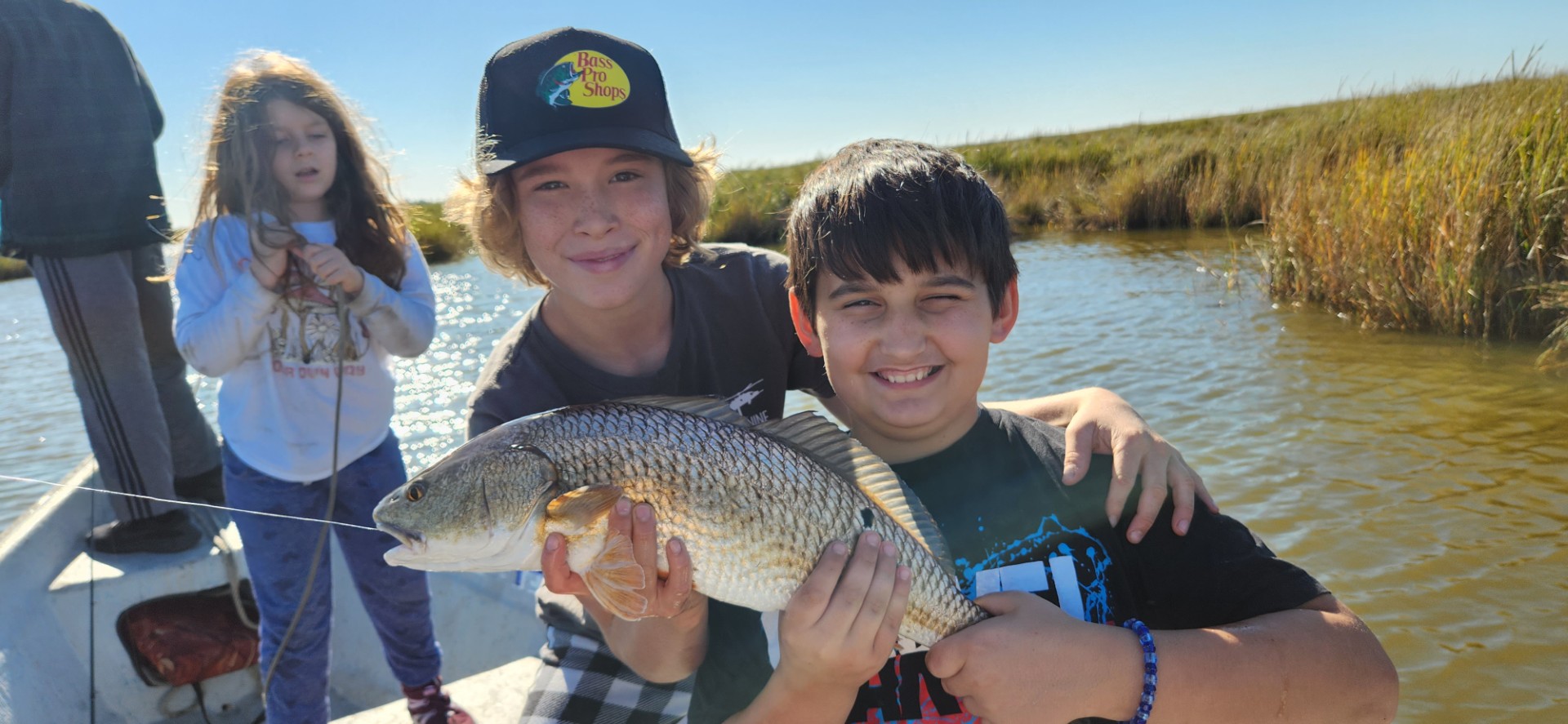 BFF members out on the bayou together, lines in the water on a clear day